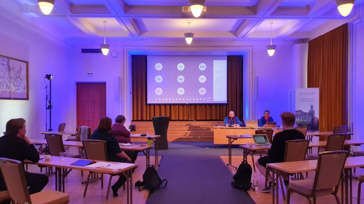 Edustajiston kokous käynnissä Paasitornissa, valkokankaalla etäosallistujien nimikirjaimia